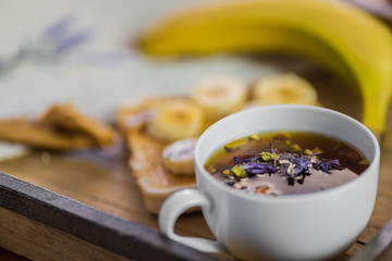 cup of hot tea with breakfast on a background