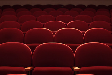 Red seats in theater hall with lens flare
