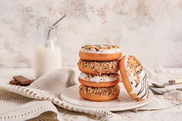 Composition with tasty donuts and milk on table