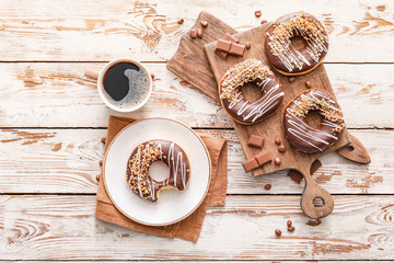 Composition with tasty donuts and coffee on table