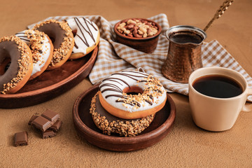 Composition with tasty donuts and coffee on table
