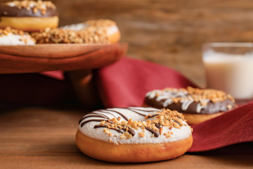 Sweet tasty donuts on table