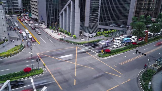 Time lapse of traffic moving through junction on Ayala Avenue in Makati
