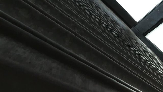 Corrugated metal store roller shutters opening closeup low angle shot revealing sky