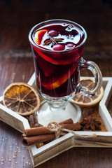 Mulled wine with orange and spices in glass mug