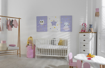 Baby room interior with cute posters, crib and clothing rack