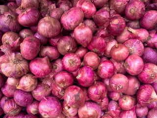 red onions laid for selling at a vegetable vendor