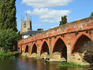 Obraz premium Great Barford Packhorse Bridge and All Saints Church Tower. Bedfordshire England.