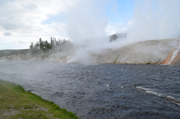 Late Spring in Yellowstone National Park: Steam Rolls Off Excelsior Geyser Crater Next to Firehole River in Midway Geyser Basin Along the Grand Loop Road