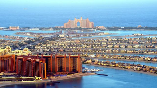 An eye catching view of Atlantis The Palm & pretty fronds zooming out & panning around the hotel and its residential neighborhood & street life, 6-axis stabilized gimbal, Shotover F1, 8K, parallax.