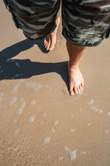 Fototapeta na wymiar Walking on the beach, feet detail