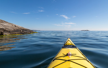 A yellow kayak in the calm sea. Kayaking in archipelago 