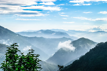A beautiful view of the Himalayas in Sikkim, India in June, where clouds and fog cover the mountains