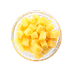 Raw yellow carrot cubes in glass bowl isolated on white, top view