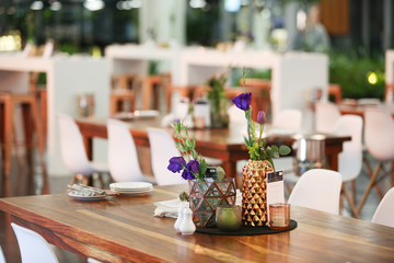 purple flowers in a copper vase set up for an event.