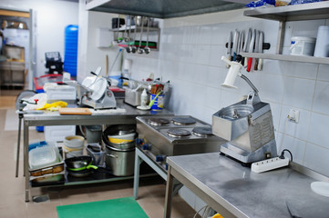 Interior of kitchen in restaurant and desk.