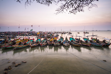 Fototapeta na wymiar traditional fishing boat leaning on the beach in the morning rembang central java