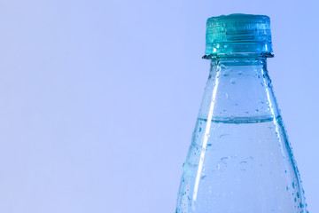 Plastic bottle of pure water on color background, closeup. Space for text
