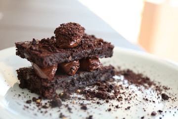 Delicious chocolate brownie dessert on plate, closeup view