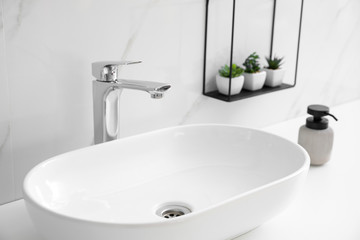 Stylish vessel sink on bathroom counter. Interior design