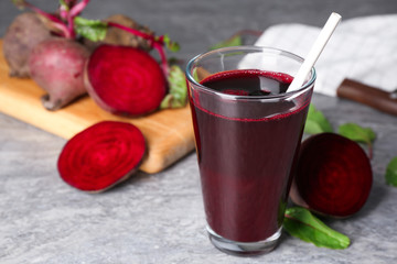 Freshly made beet juice on grey table