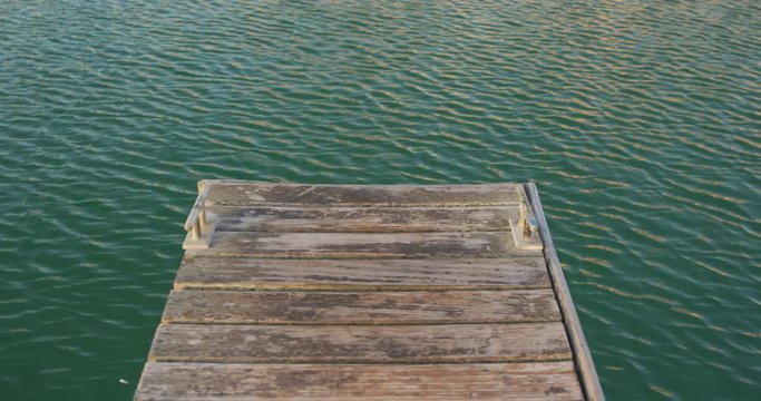 Magnificent view of an end of a jetty and small waves on a calm sea water