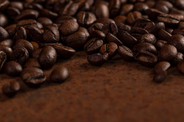 Roasted coffee beans on rusty background