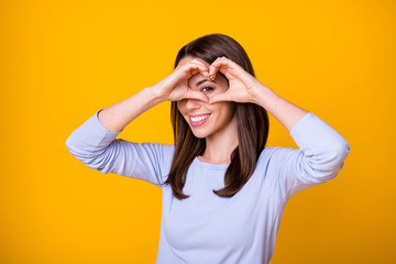 Photo of positive cheerful girl make fingers heart enjoy passionate love look eye face wear purple shirt isolated over bright shine color background