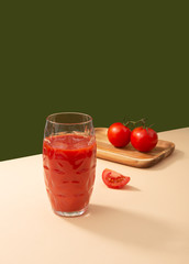 Tomato juice and tomatoes on the table