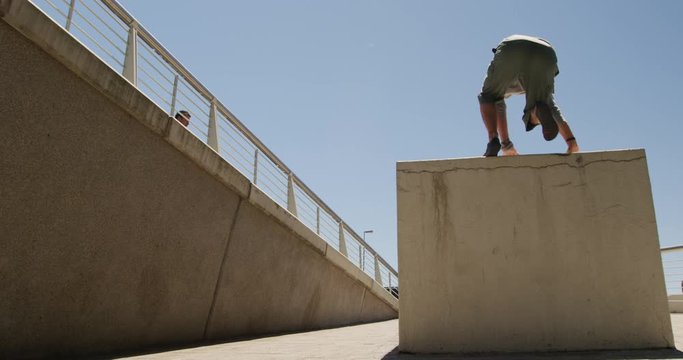 Caucasian men practicing parkour