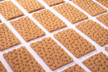 Crispbread on a white table, isometric creative minimalism concept