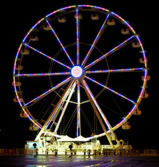 bright ferris wheel lights brighten the night in an amusement park