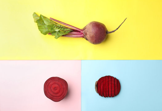 Whole and cut fresh red beets on color background, flat lay