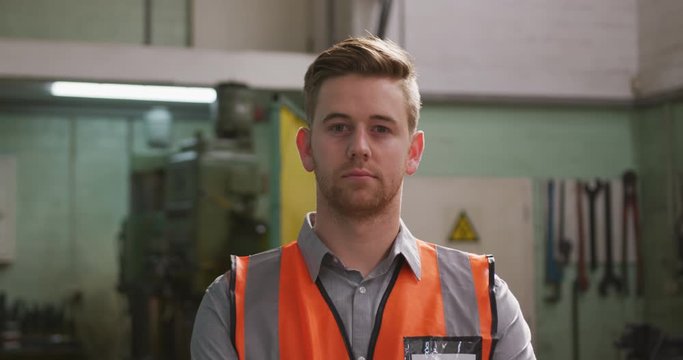 Caucasian Male Factory Worker At A Factory Wearing A High Vis Vest