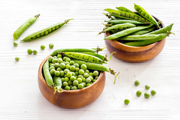 Bowl of green pea pod with beans on kitchen desk. Close up
