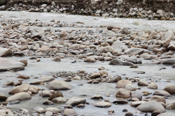 View of the mountains and stream of melting snow from Everest on the way to Everest Base Camp, Tibet, China