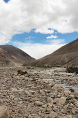 View of the mountains and stream of melting snow from Everest on the way to Everest Base Camp, Tibet, China