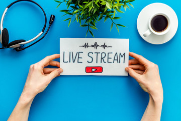 Live streaming web network concept. Female hands holding paper tablet. Top view