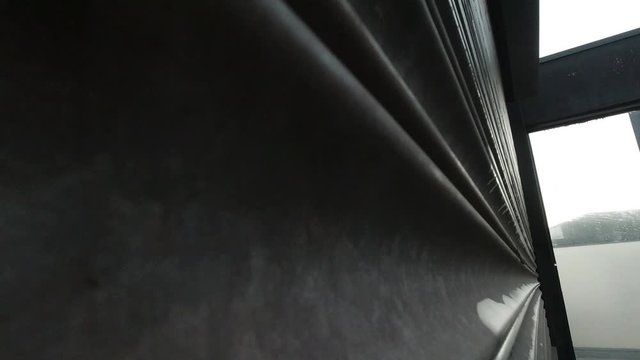 Corrugated metal store roller shutters opening closeup