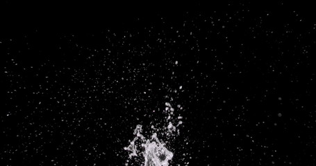 water splattering up on a black background.