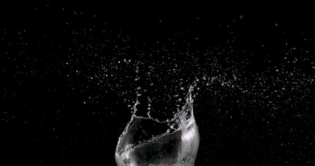 water rising up from the center of a black background.