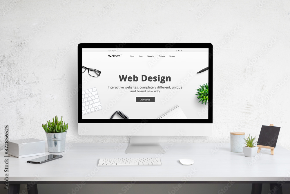 Poster Web design company web site concept on computer display. Modern flat design website. Office desk with plants, phone, keyboard and mouse.