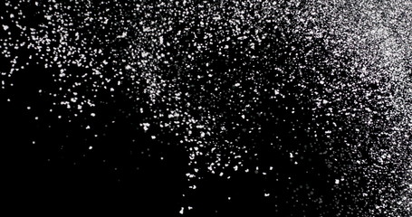 Naklejka na ściany i meble White snowflakes falling slowly against an isolated black background.
