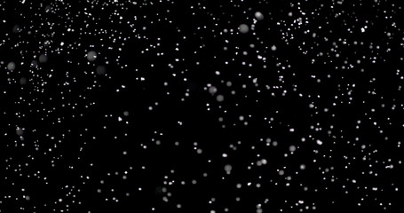 Blizzard of snow at night. It shows the white flakes moving fast on the isolated black background.