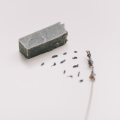 Handmade soap bars and lavender on white background, top view. Lavender flowers ang natural soaps for bodycare 