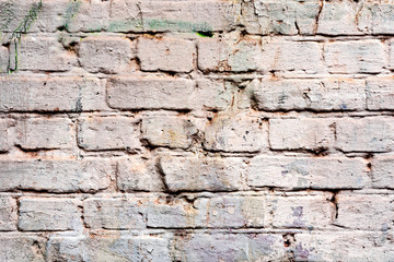 Weathered texture of stained old dark white and orange brick wall background