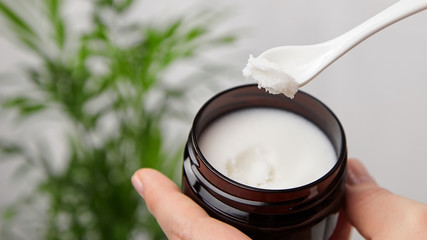 Pure shea butter in spoon and jar. Skin and hair care product, natural cosmetics.