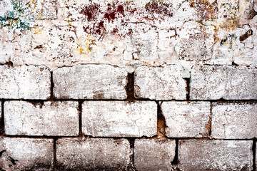 Weathered texture of stained old dark white and orange brick wall background