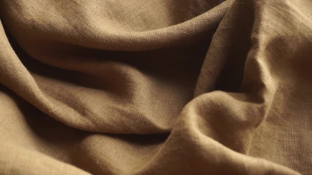 Linen fabric background. Linen textile cloth with fabric texture and pattern. Production of clothing and natural environmentally friendly materials.