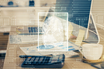 Computer on desktop in office with finger print drawing. Double exposure. Concept of business data security.